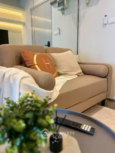 Stylish modern living room with cozy sofa and elegant decor, perfect for relaxation and comfort.