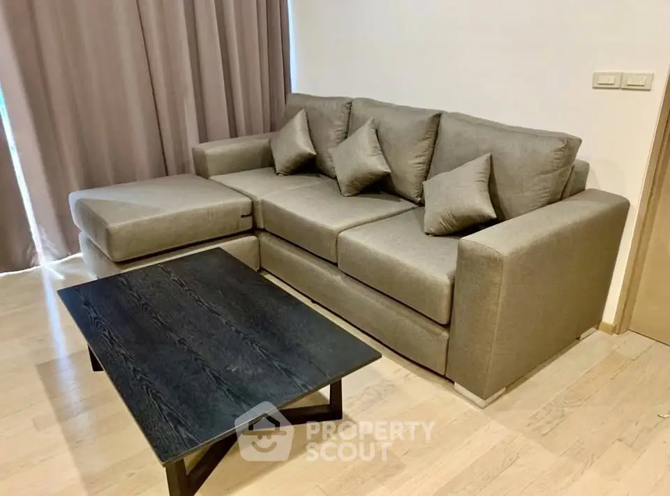 Modern living room with stylish sofa and sleek coffee table, perfect for relaxation and entertaining.
