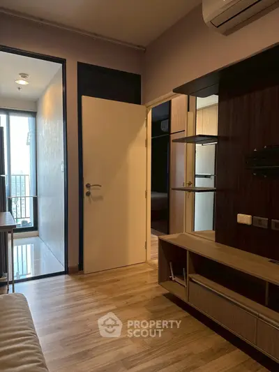 Modern living room with wooden flooring and stylish shelving unit