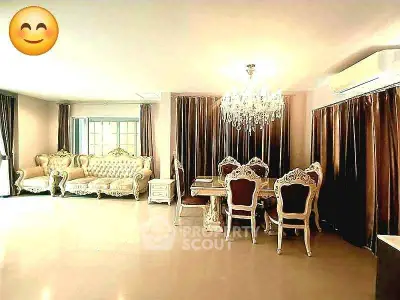 Luxurious living room with elegant furniture and chandelier, perfect for sophisticated living.