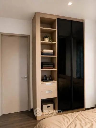 Modern bedroom with sleek wardrobe and organized shelving, featuring a cozy and stylish design.