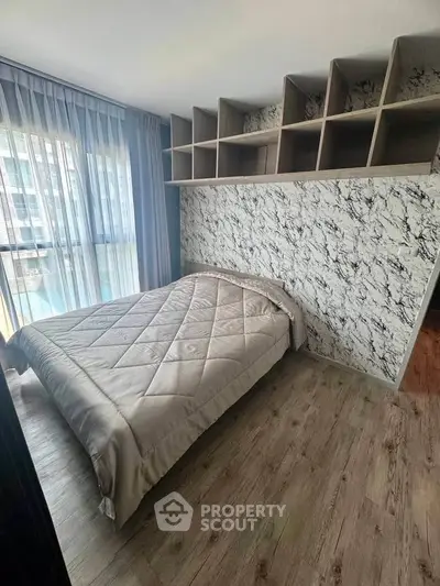Modern bedroom with stylish decor and ample natural light, featuring a cozy bed and unique shelving.