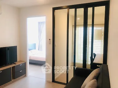 Modern apartment interior with sliding glass doors and cozy living area