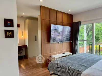 Modern bedroom with wall-mounted TV and balcony view