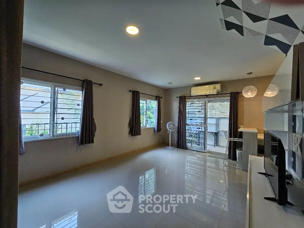 Spacious living room with modern design and large windows for natural light.
