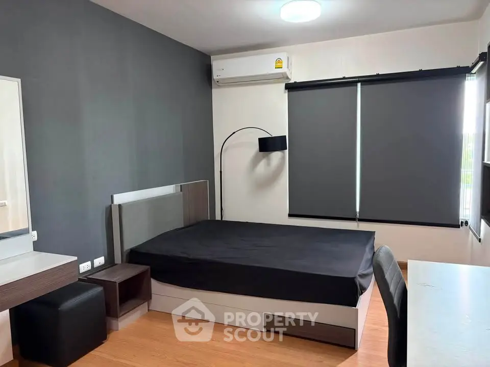 Modern bedroom with sleek design, featuring a comfortable bed, stylish lighting, and large windows with blinds.