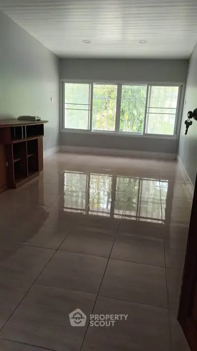 Spacious empty room with large windows and glossy tiled floor, perfect for customization.