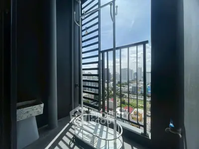 High-rise balcony with city view and drying rack, perfect for urban living.