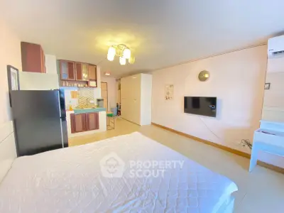 Spacious studio apartment with modern kitchen and cozy living area, perfect for urban living.
