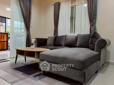 Modern living room with plush gray sectional sofa and stylish coffee table.