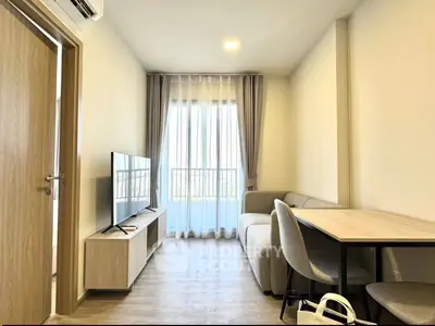 Modern living room with sleek furniture and natural light, perfect for cozy living.