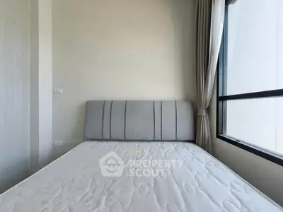 Modern bedroom with large window and minimalist decor