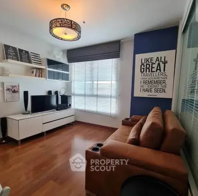 Stylish living room with modern decor, cozy brown sofa, and large window for natural light.
