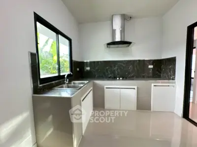 Modern kitchen with sleek design and stainless steel sink