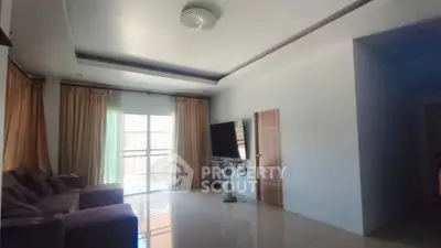 Spacious living room with modern decor and large windows for natural light.