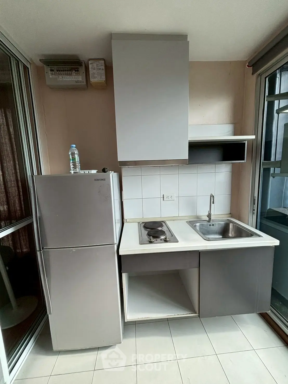 Compact kitchen with modern appliances and sleek cabinetry in a cozy apartment setting.