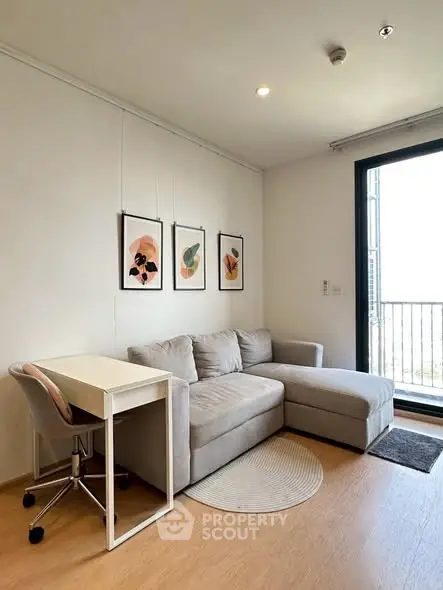 Modern living room with cozy sofa, stylish decor, and balcony access in a contemporary apartment.