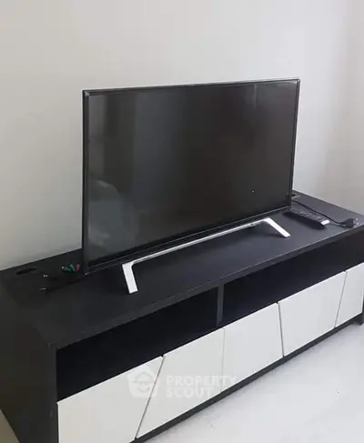 Modern living room with sleek TV stand and flat-screen television