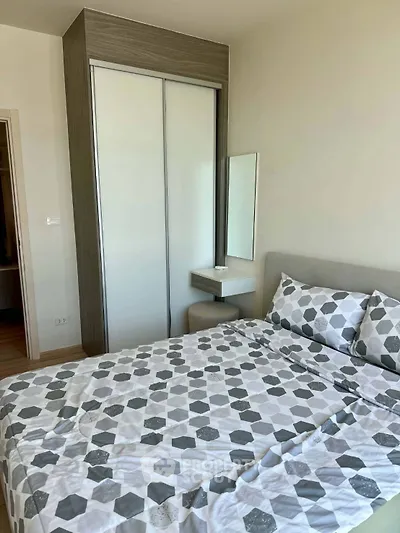Modern bedroom with stylish geometric bedding and built-in wardrobe