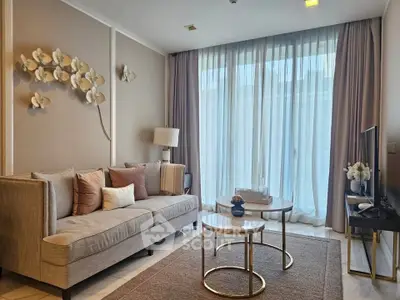 Elegant living room with modern decor and large window, perfect for relaxation.