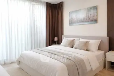 Elegant bedroom with modern decor and large window for natural light