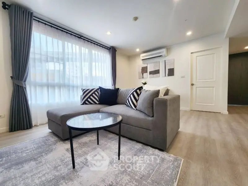 Modern living room with stylish gray sofa and chic decor