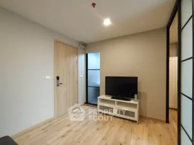 Modern living room with wooden flooring and sleek TV stand