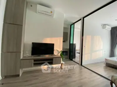 Modern living room with sleek furniture and large windows in a stylish apartment.