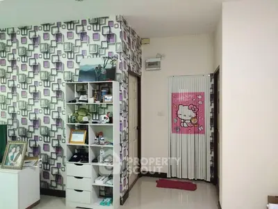 Charming interior with playful wallpaper and organized shelving in a cozy living space.