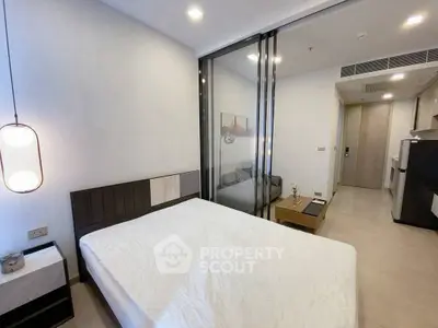 Modern bedroom with glass partition and minimalist decor in a stylish apartment.