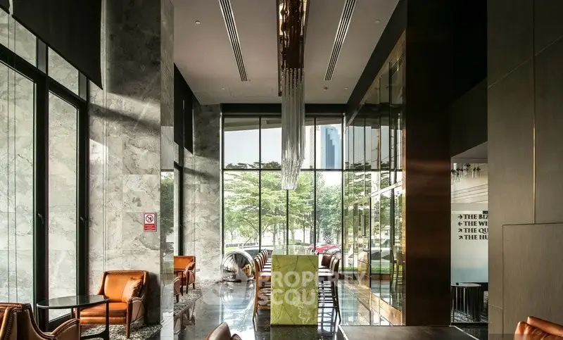 Luxurious modern lobby with high ceilings and elegant decor in a prestigious building.