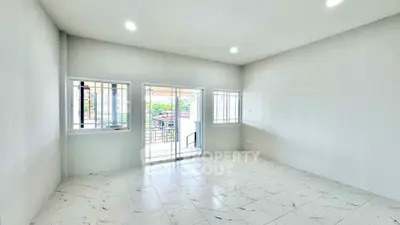 Spacious bright room with tiled floor and large windows leading to a balcony, perfect for modern living.