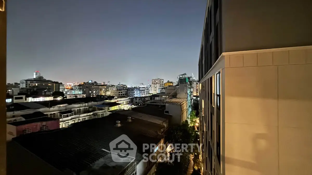 Stunning cityscape view from high-rise building at night, showcasing urban skyline and vibrant lights.