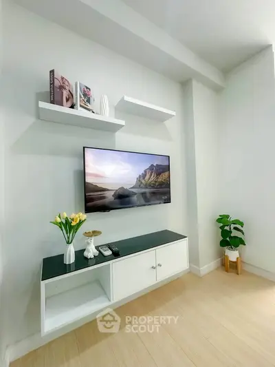 Modern living room with wall-mounted TV and stylish decor