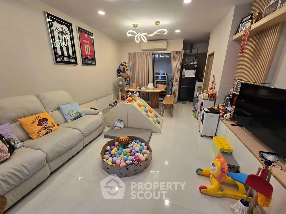 Spacious living room with modern decor and playful children's area