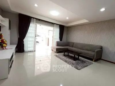 Spacious living room with modern decor and large windows for natural light.