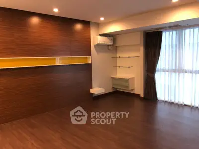 Spacious modern living room with wooden flooring and stylish wall accents