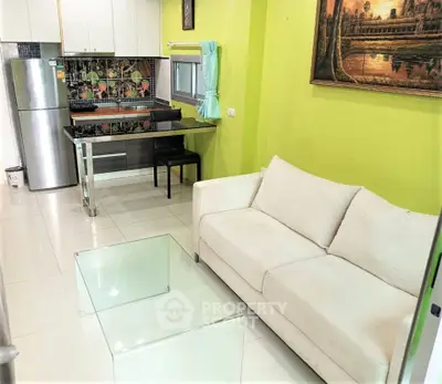 Modern open-layout living room with kitchen, featuring sleek furniture and vibrant decor.