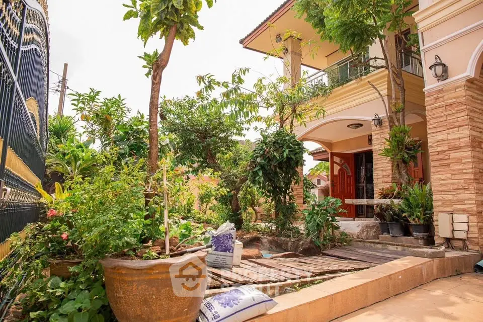 Charming two-story home with lush garden and inviting entrance