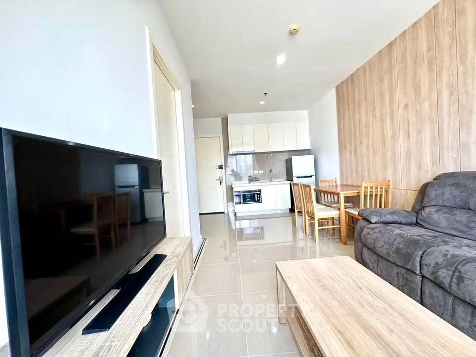 Modern living room with sleek furniture and open kitchen layout