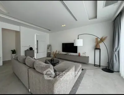 Modern living room with sleek gray sofa and stylish decor in a spacious open layout.