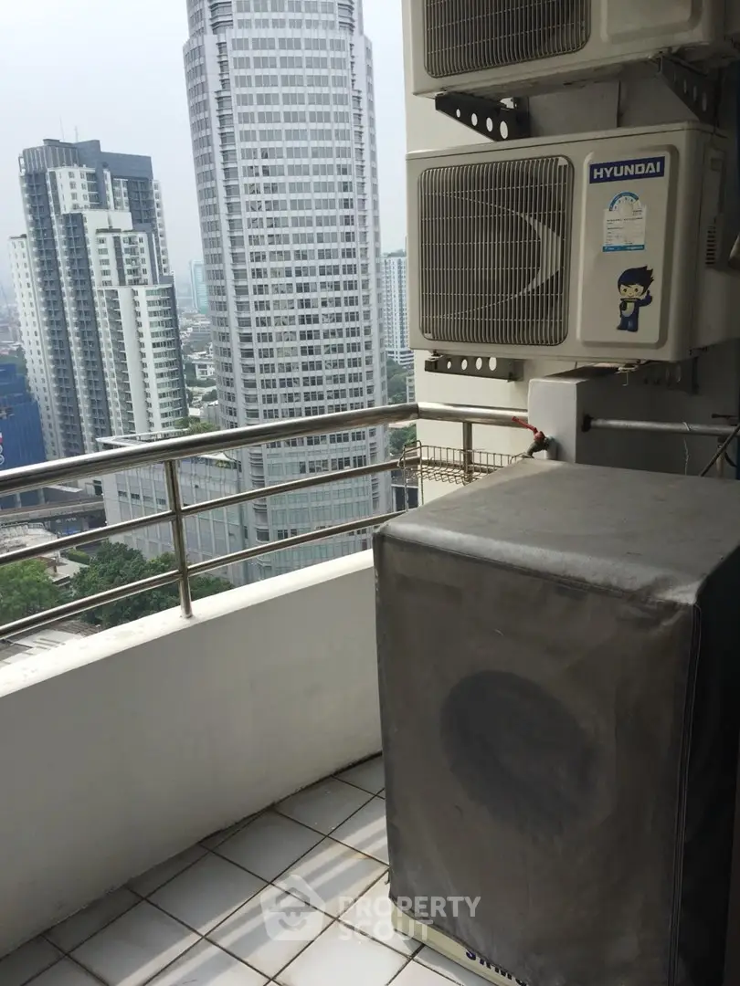 High-rise balcony with city view and air conditioning units, perfect for urban living.