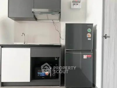 Modern compact kitchen with sleek appliances and minimalist design