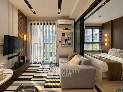 Modern living room with stylish decor and adjacent bedroom in a cozy apartment.