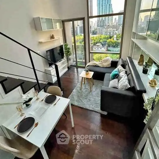 Modern loft-style living room with city view, featuring sleek furniture and open layout.