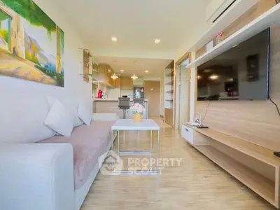 Modern open-plan living room with sleek kitchen and cozy seating area