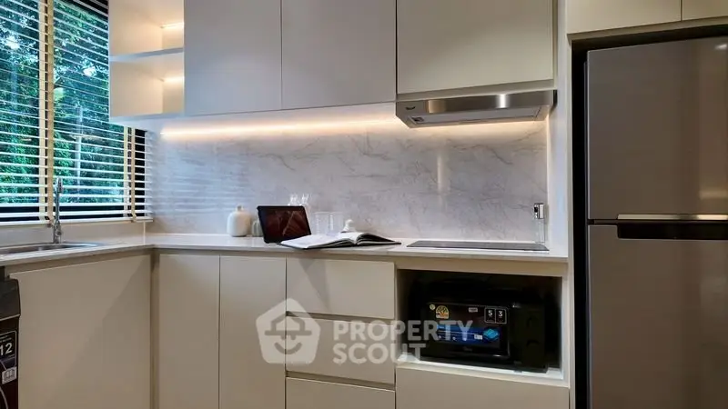 Modern kitchen with sleek cabinets and stainless steel appliances