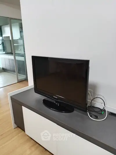 Modern living room with sleek TV and stylish cabinetry