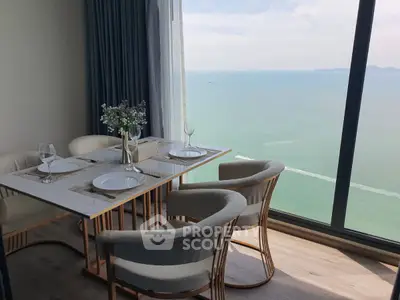 Luxurious dining area with stunning ocean view from high-rise apartment