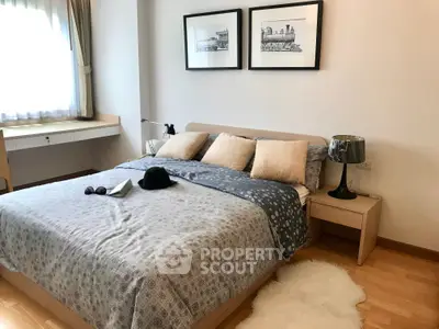 Cozy bedroom with stylish decor and natural light, featuring a comfortable bed and elegant furnishings.